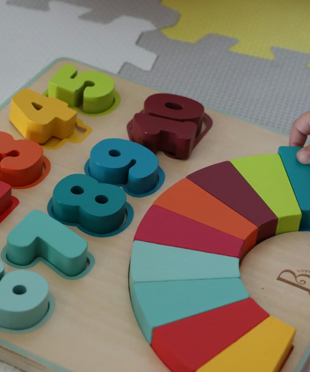 Child playing with a wooden toy